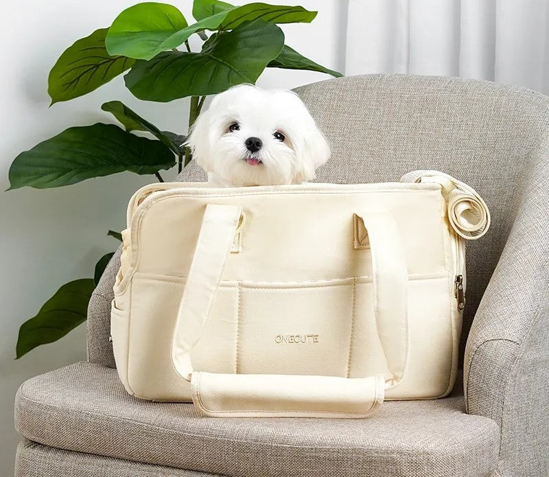 Image of small pet carrier with small dog inside on left
