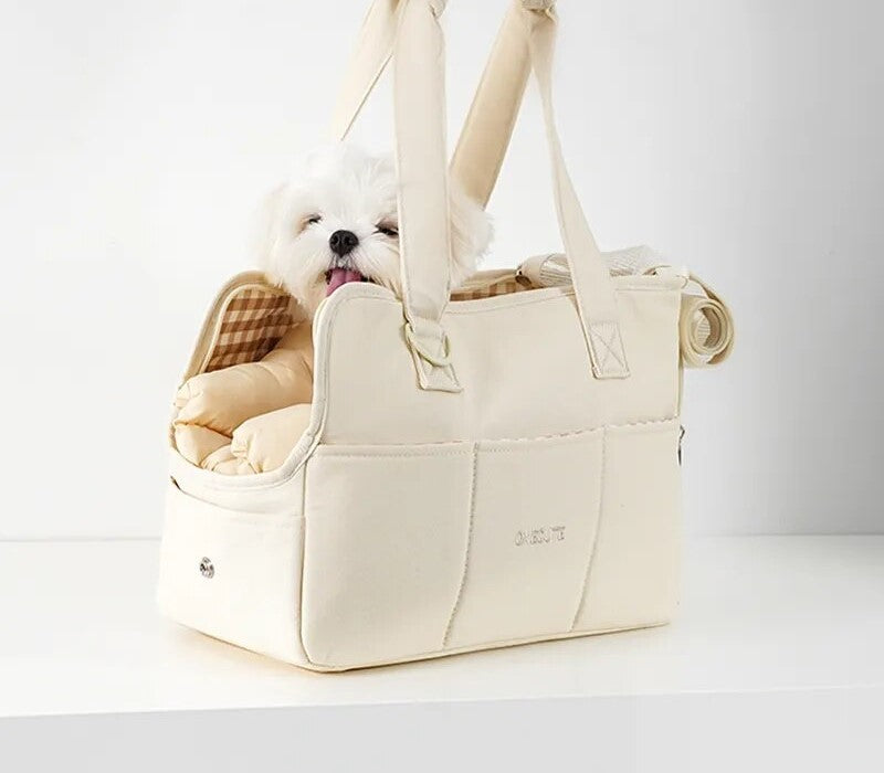 Image of small pet carrier with small dog inside in middle